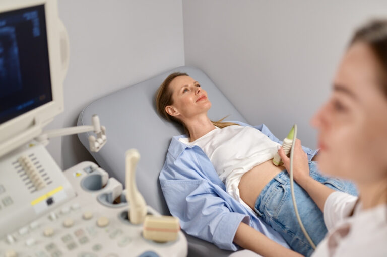 Doctor examining a patient with an abdominal ultrasound
