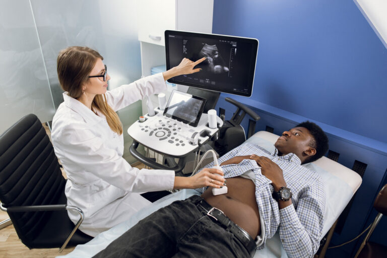 Sonographer conducting an abdominal ultrasound test, showing the scan image on screen