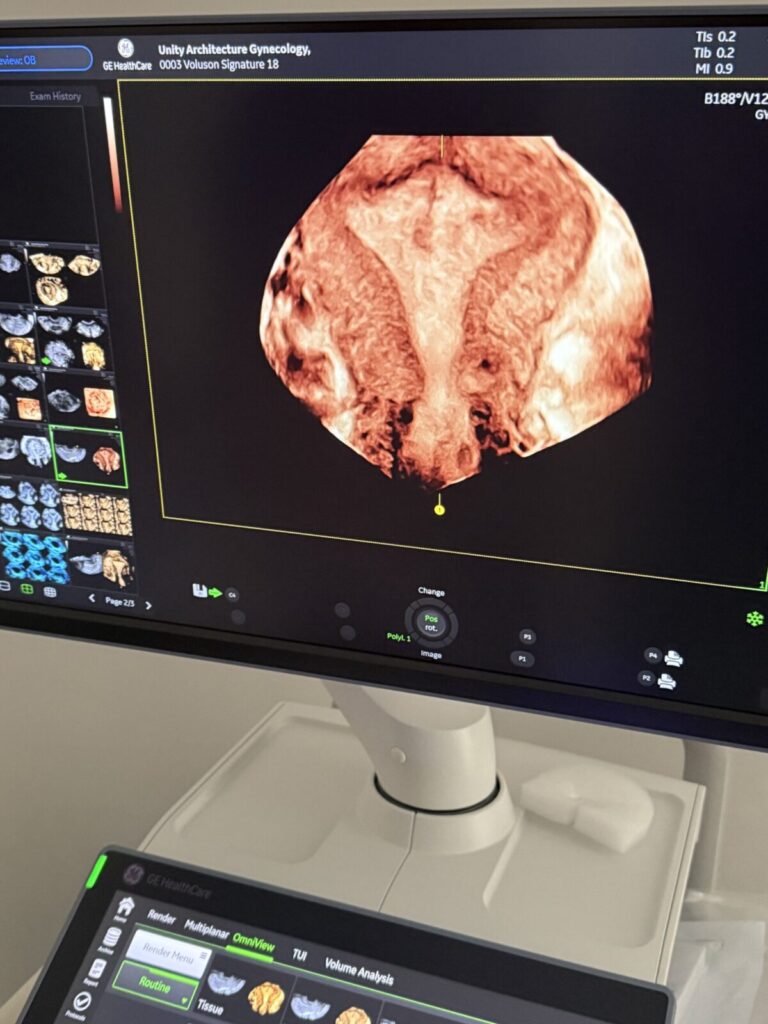 Sonographer performing an ultrasound scan in clinic