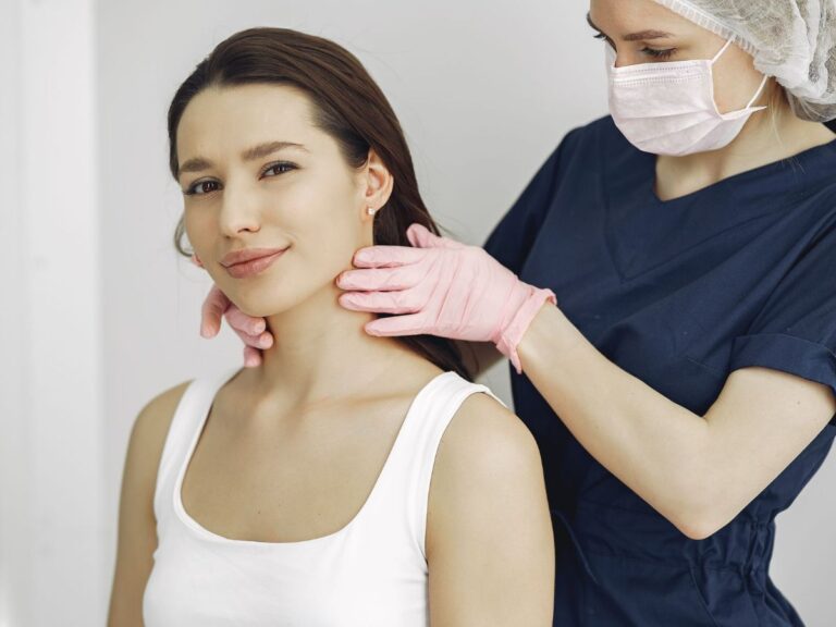 Clinician examining a lump on a patient's neck