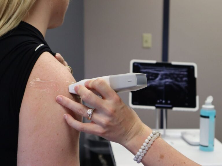 Sonographer performing an ultrasound scan of a patient's shoulder